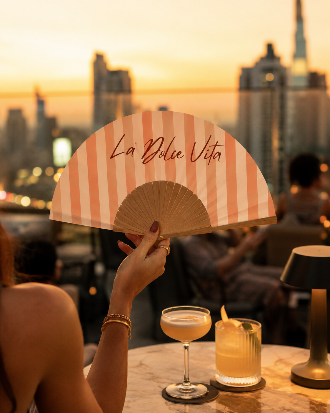 Custom VEYOO hand fan at a rooftop bar in Bangkok